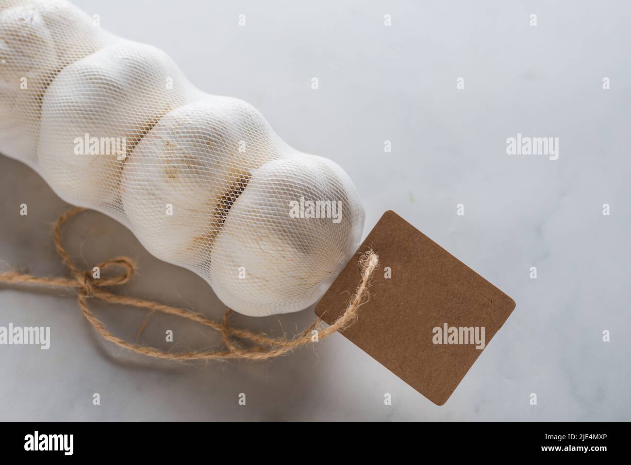 Mesh bags of garlic Stock Photo Alamy