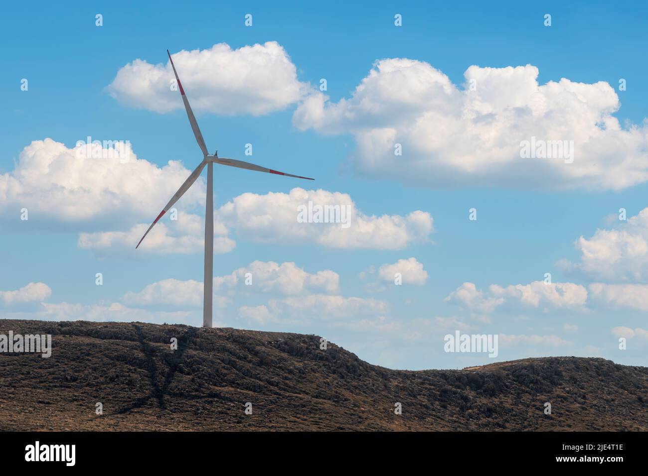 Windmill for renewable electricity generation at sunset Stock Photo