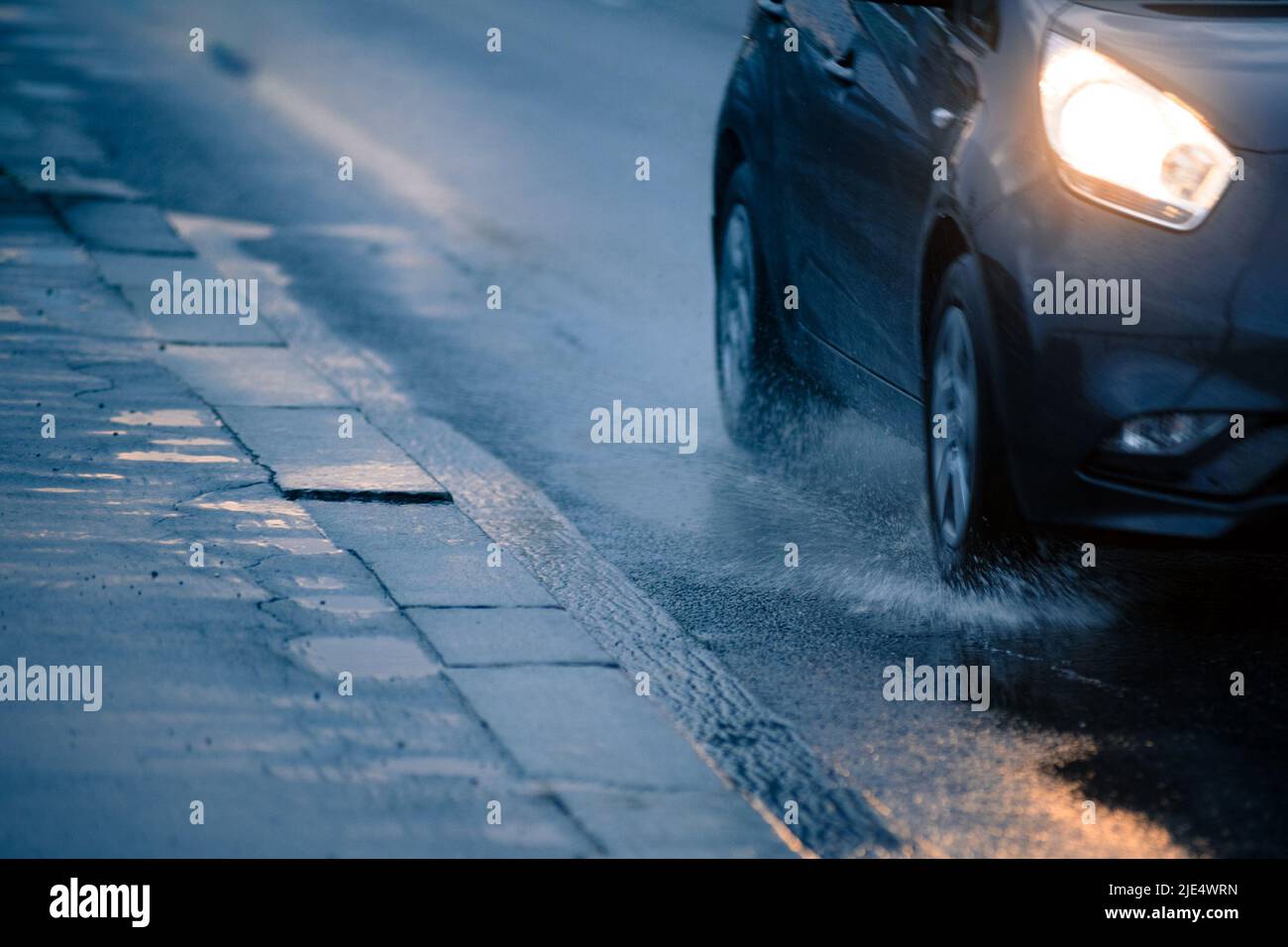 Fragment of car on wet road Stock Photo