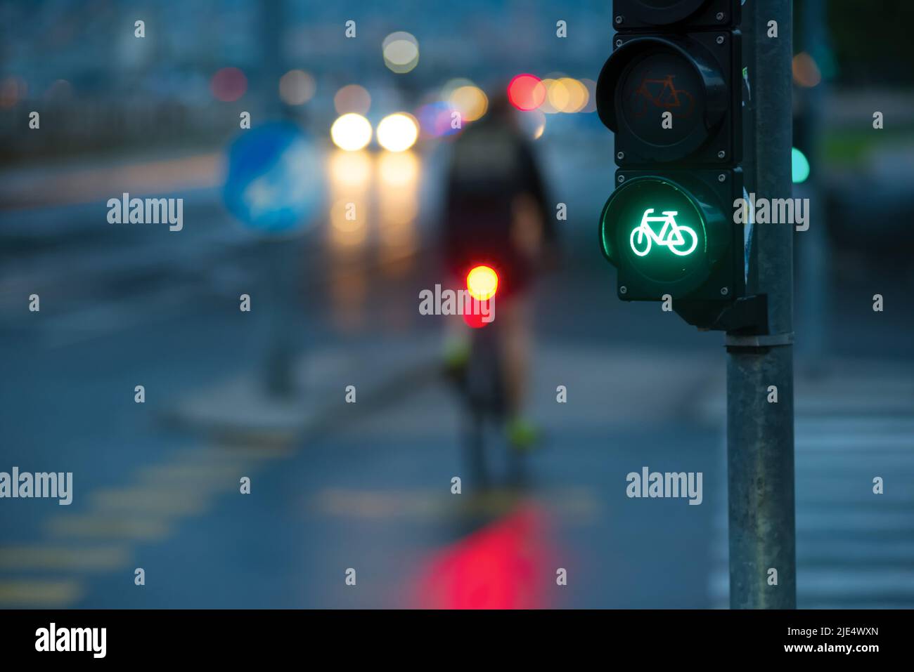 Traffic light and blurred bicyclist in the city Stock Photo