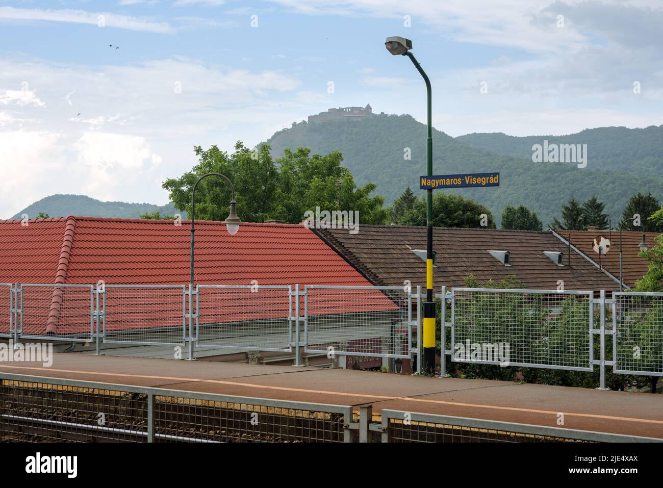 Nagymaros railway station in Hungary against distant view of Visegrad castle Stock Photo