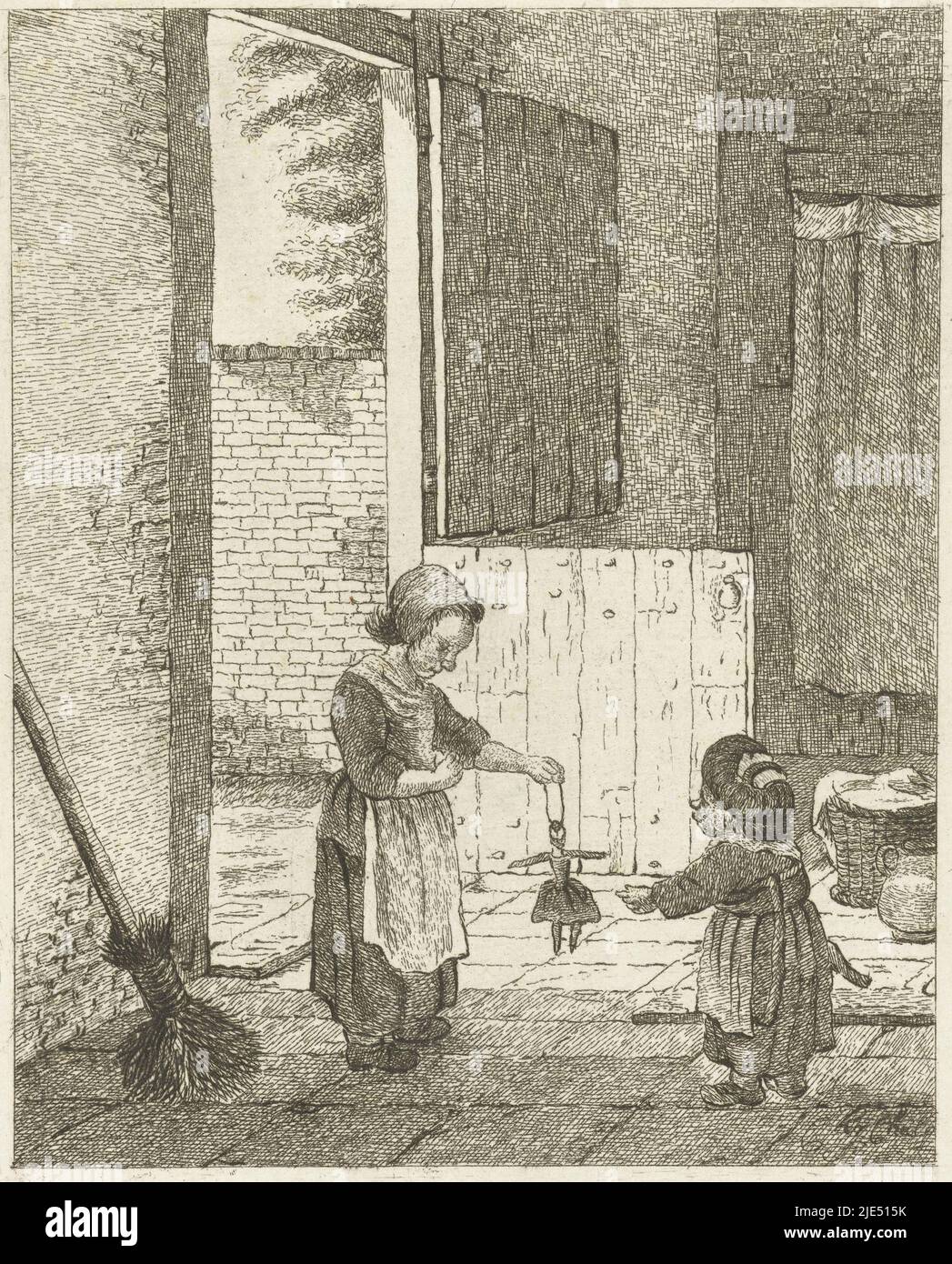 Two girls playing with a doll in the kitchen. A door to the