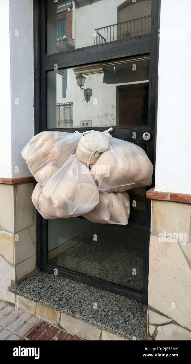 Early morning bread delivery left hanging on entrance door Stock Photo