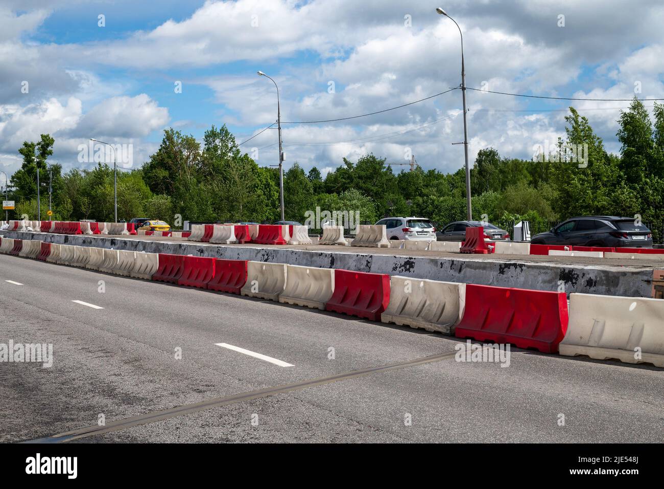 Moscow, Russia - June 04. 2022. Water-filled barriers stand along the road during repairs. Stock Photo
