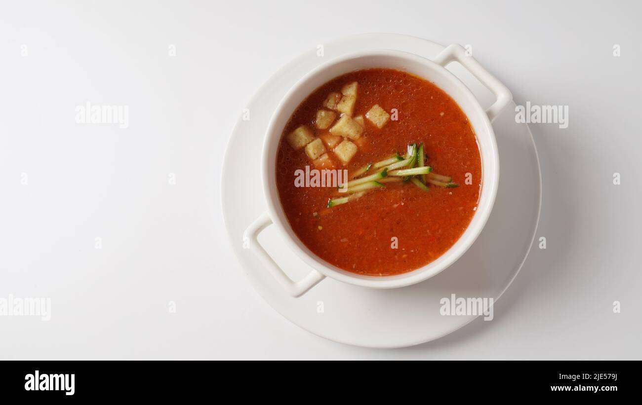 Bowl with homemade Gazpacho tomato soup, with croutons and sliced