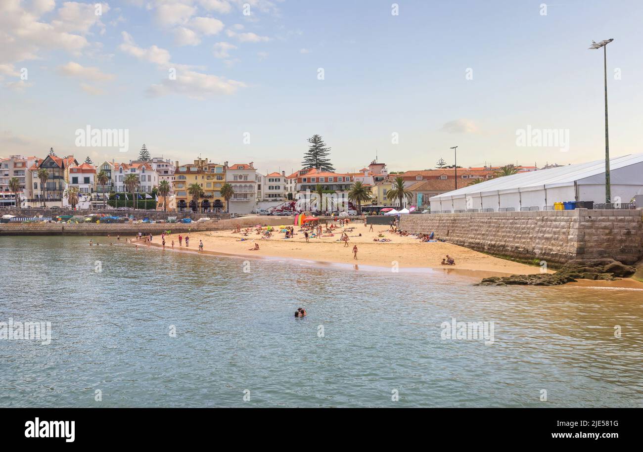 Cascais near Lisbon, seaside town. Panoramic view of beach, filled with resting people in a summer sunny day. Portugal Stock Photo