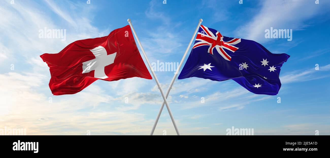 two crossed flags switzerland and Australia waving in wind at cloudy