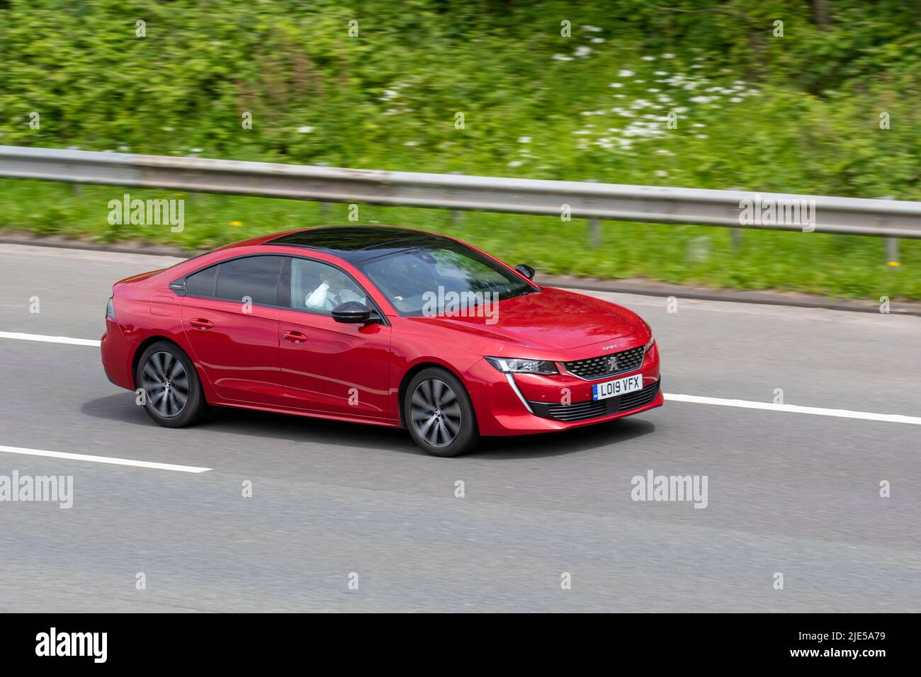 2019 red Peugeot 508 GT line Bluehdi S/S Auto 1.5L 130 EAT8 Start Stop 1500cc Diesel hatchback;  traveling on the M6 motorway, UK Stock Photo