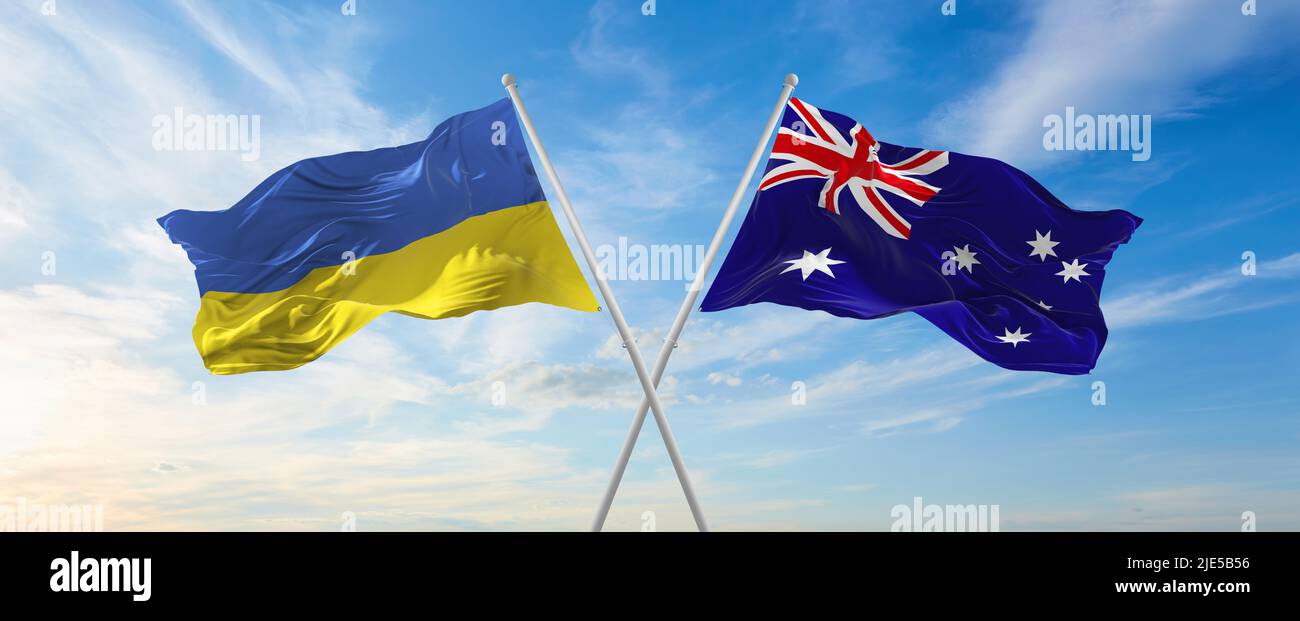 two crossed flags Ukraine and Australia waving in wind at cloudy sky. Concept of relationship, dialog, travelling between two countries. 3d illustrati Stock Photo