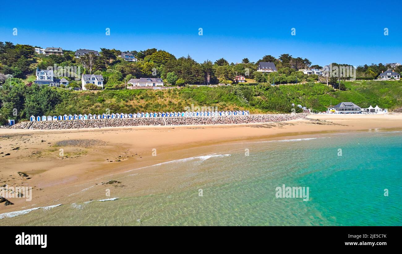 Image of Carteret beach with sand, sunshine, beach huts and a blue sky. Stock Photo