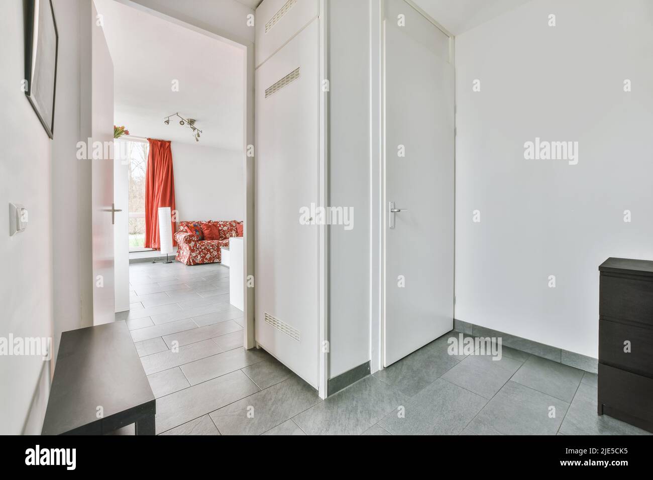 Interior of minimalist style narrow hallway with wardrobe and