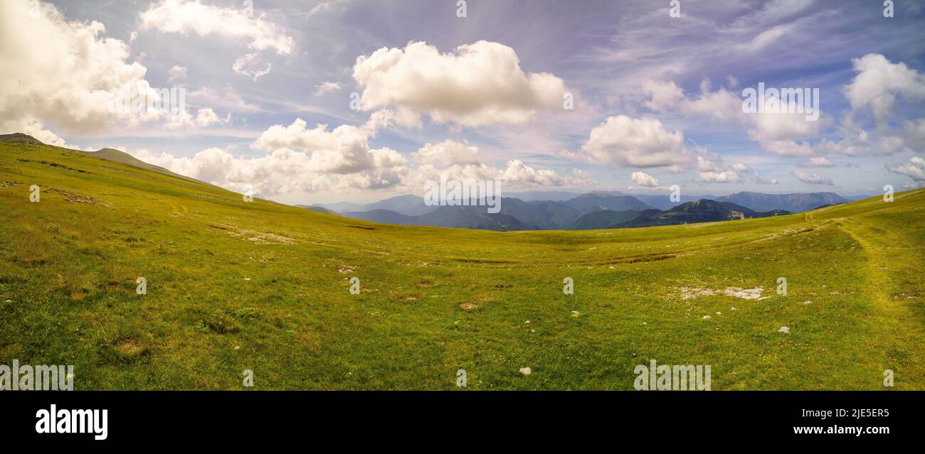Beautiful panoramic view of the Pyrenees with green meadows and golden sunset, Spain. Stock Photo