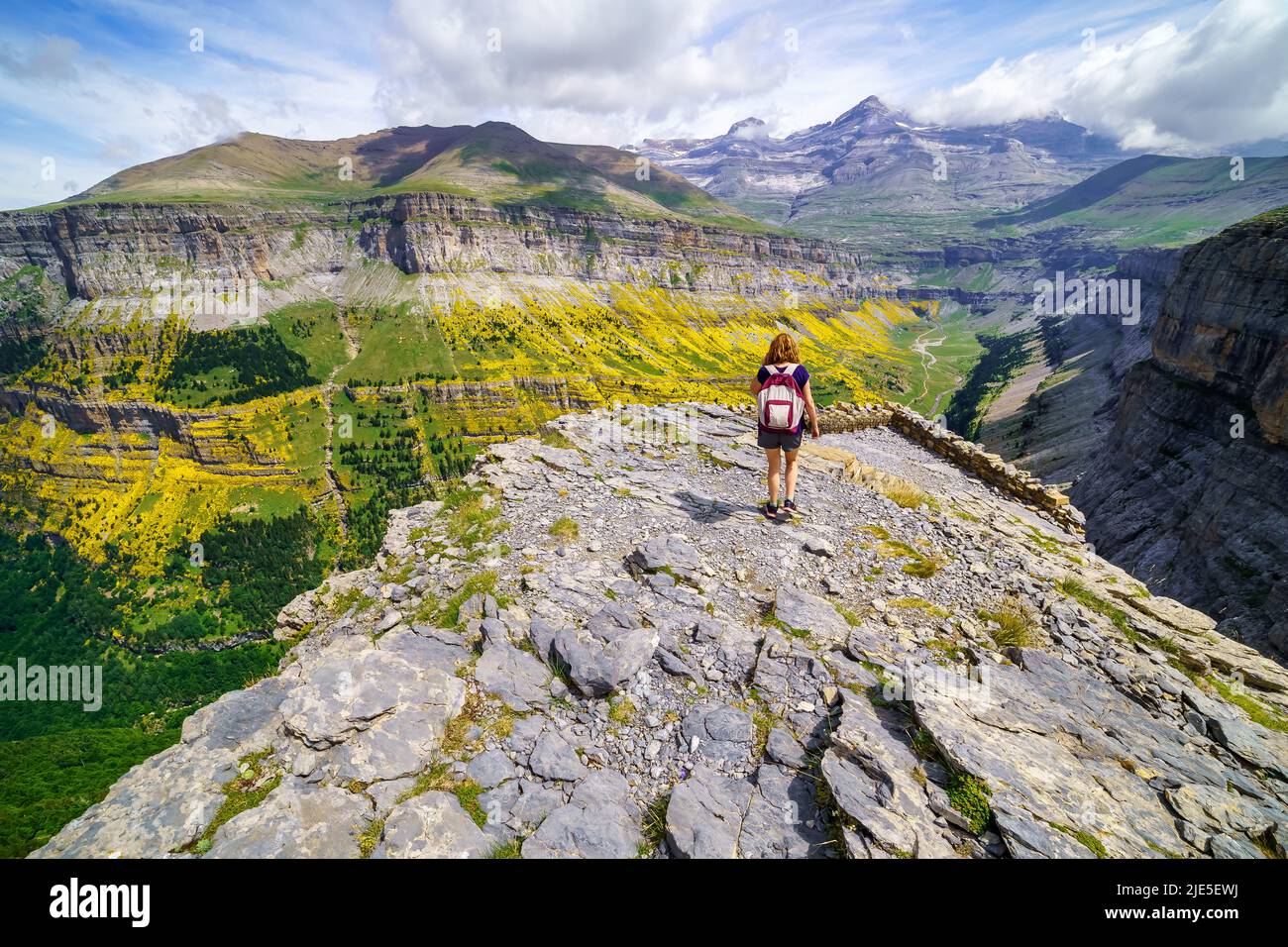 Woman hiking through the peaks of the Pyrenees in the Ordesa Valley, Spain. Stock Photo