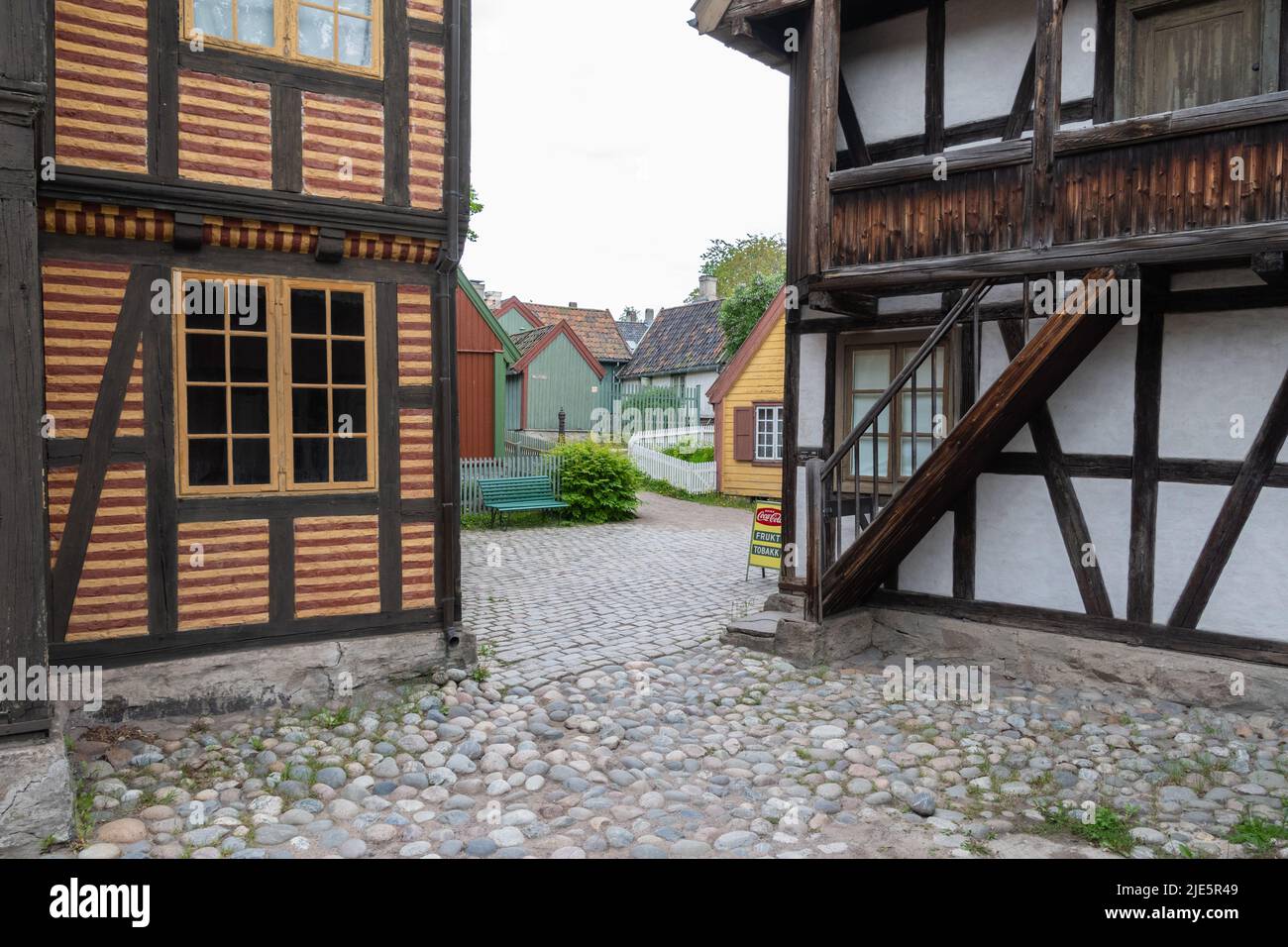 Cobblestone street and a view of town at The Norwegian Museum of Cultural History in Oslo. Stock Photo