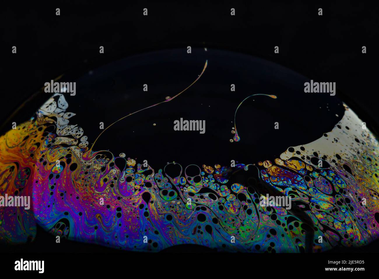 Beautiful psychedelic abstractions on the surface soap bubbles. Stock Photo