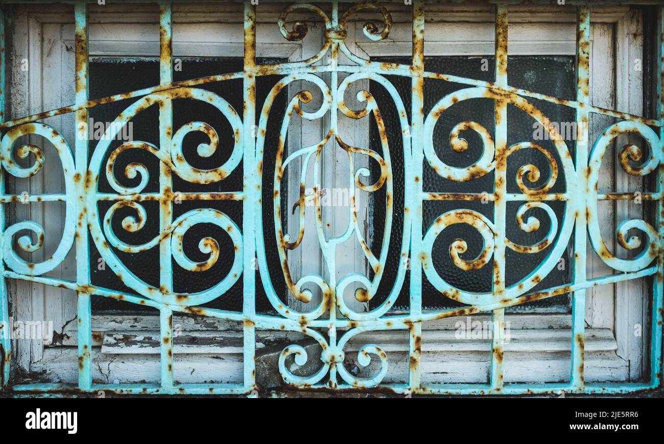 Rusted decorative iron window grate. Stock Photo