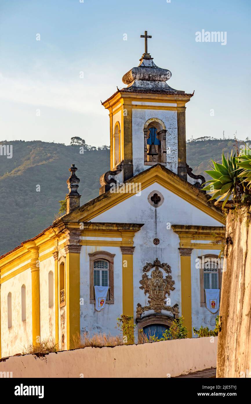 Facade of a historic church in baroque style in the city of Ouro Preto in Minas Gerais during the late afternoon Stock Photo
