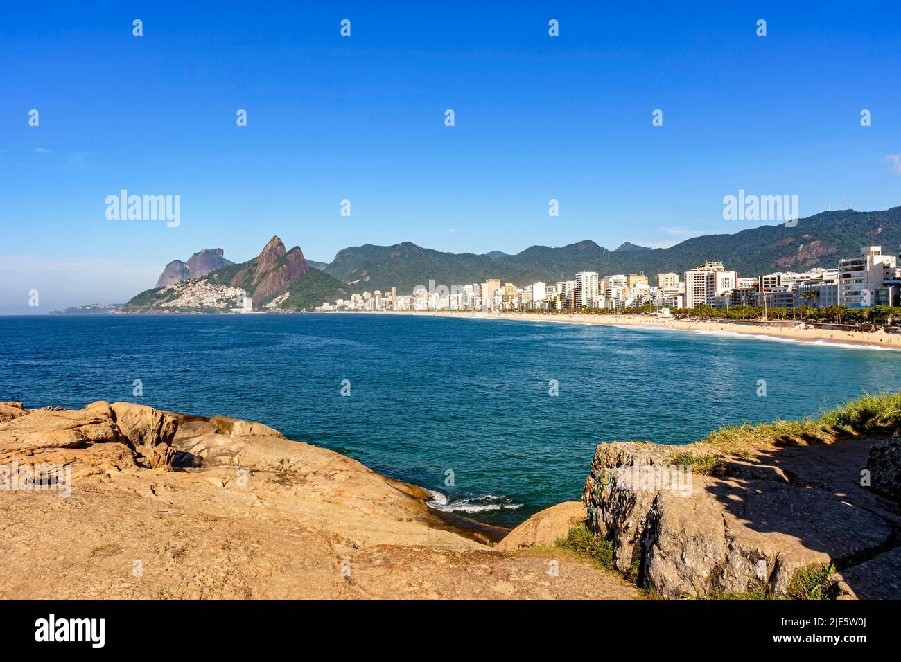 Panorama of Ipanema beach in Rio de Janeiro on a beautiful day with the sea, buildings and hills around in the morning Stock Photo