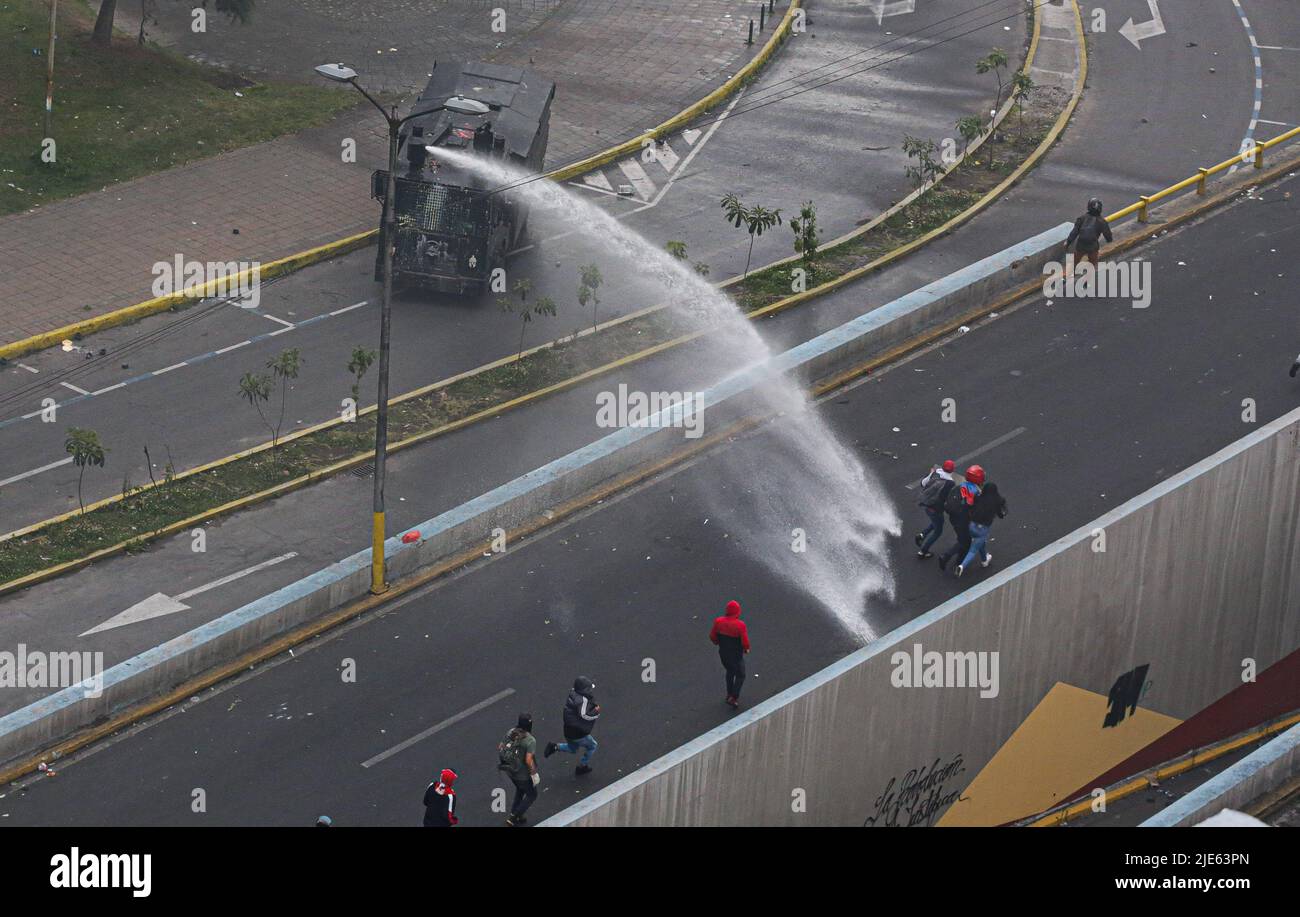 Quito, Ecuador. 24th June, 2022. A protester sneaks out of a police