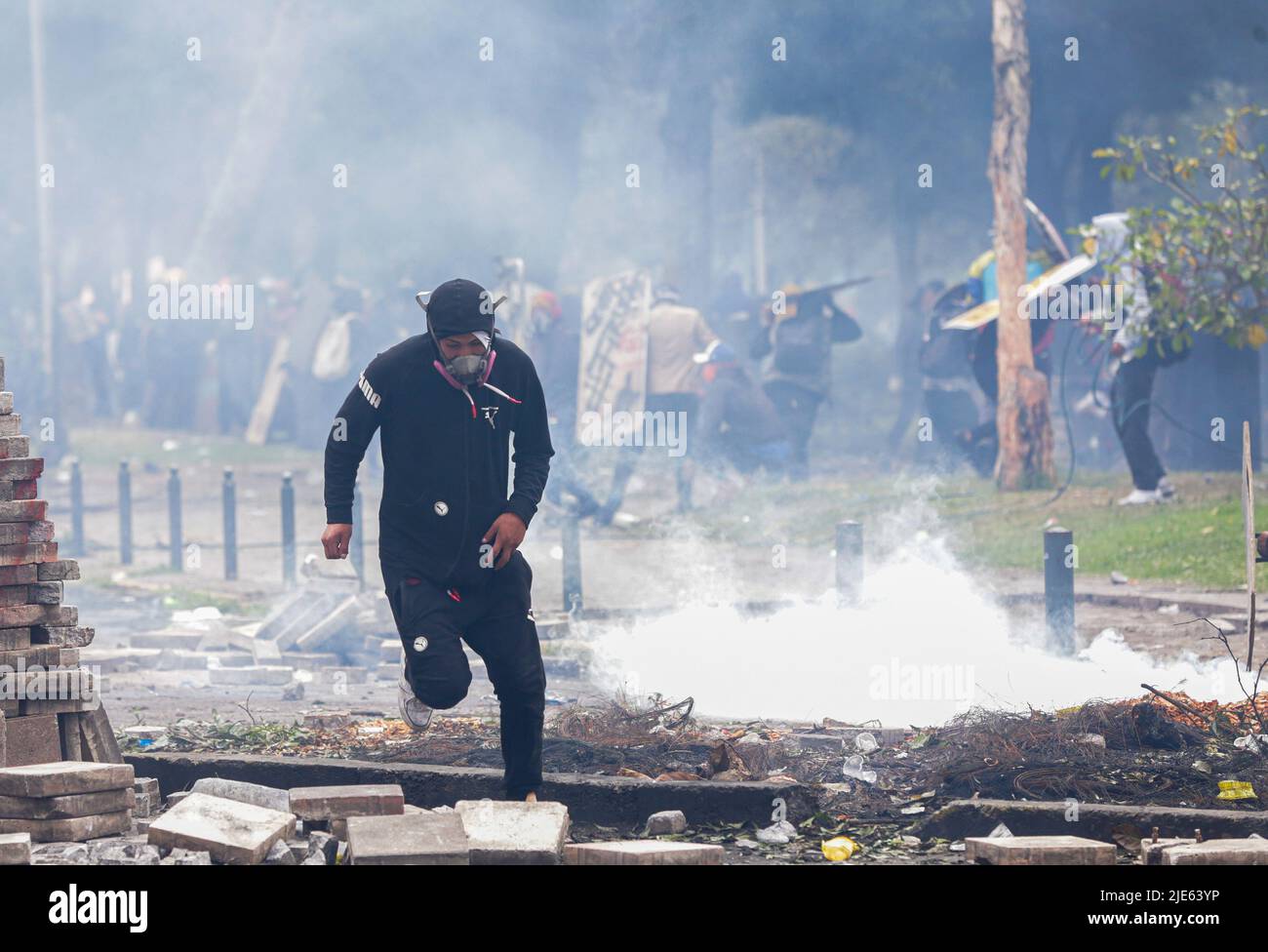 Quito, Ecuador. 24th June, 2022. A protester runs across the
