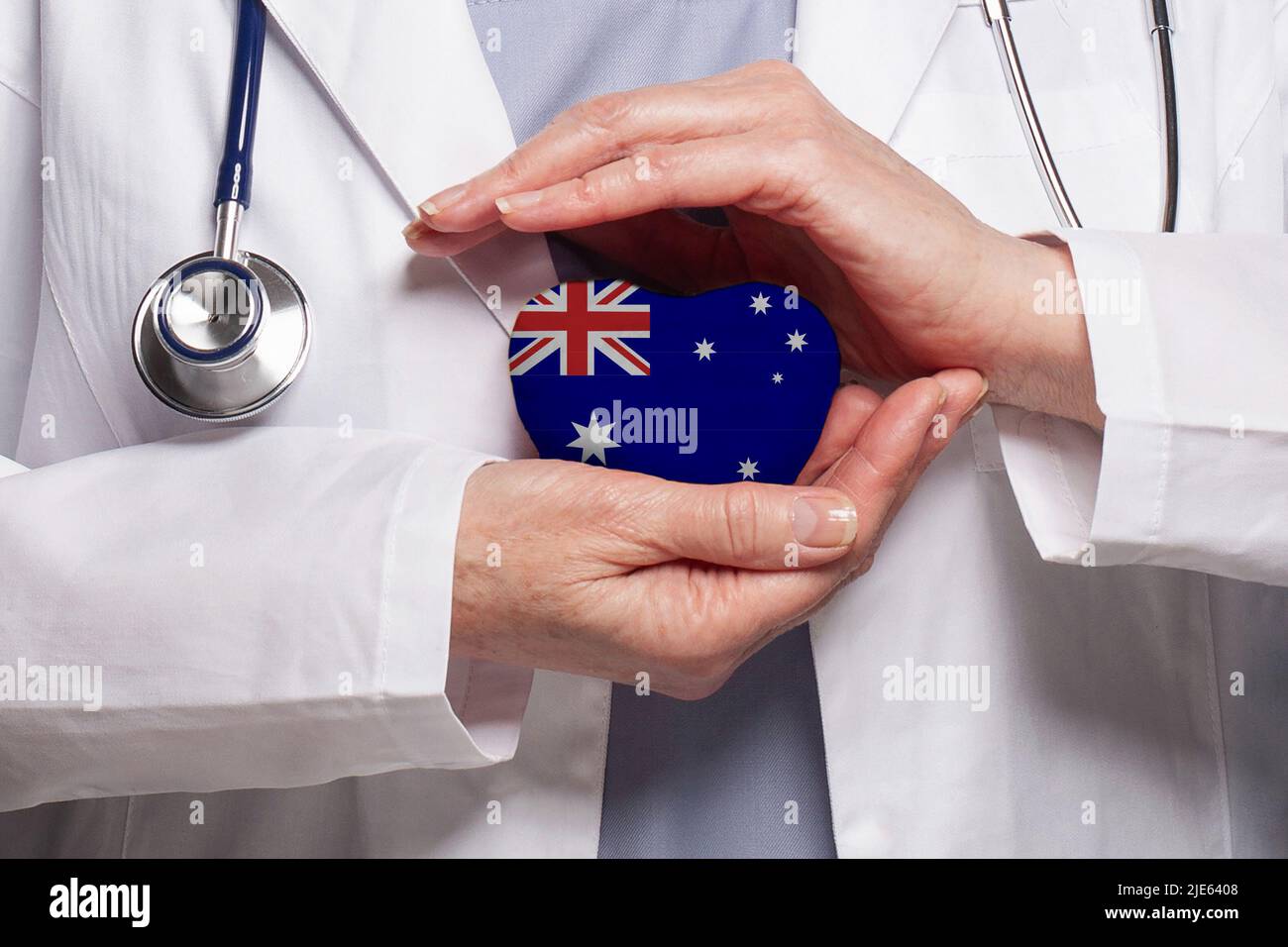 Australian doctor holding heart with flag of Australia background. Healthcare, charity