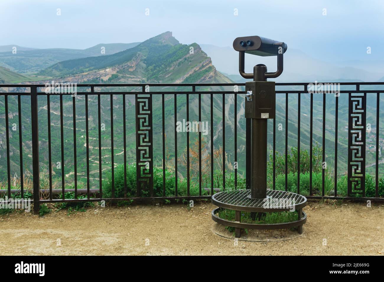 observation deck with a spotting scope over a mountain valley Stock Photo