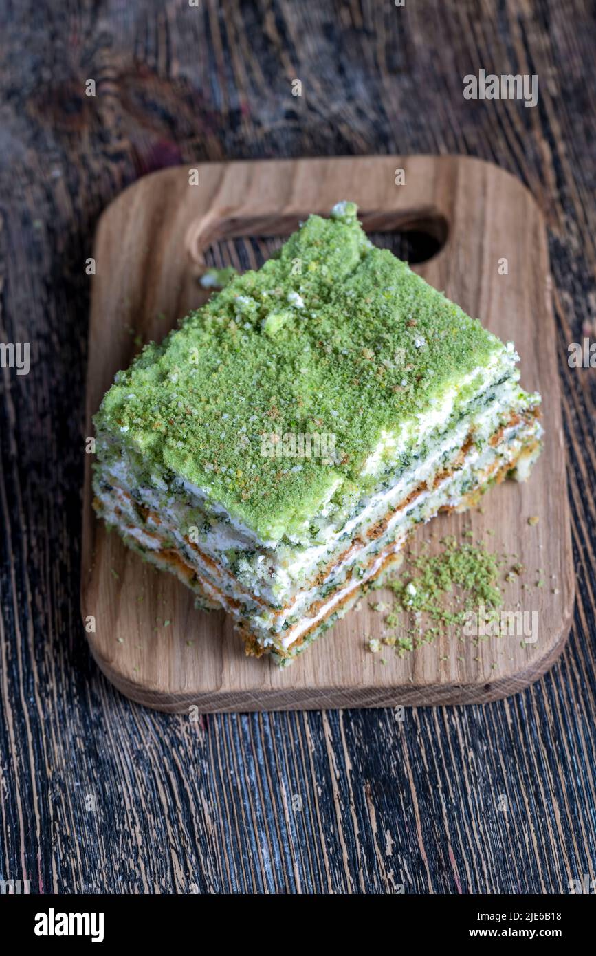 a piece of green cake with creamy filling, fresh and sweet green cake