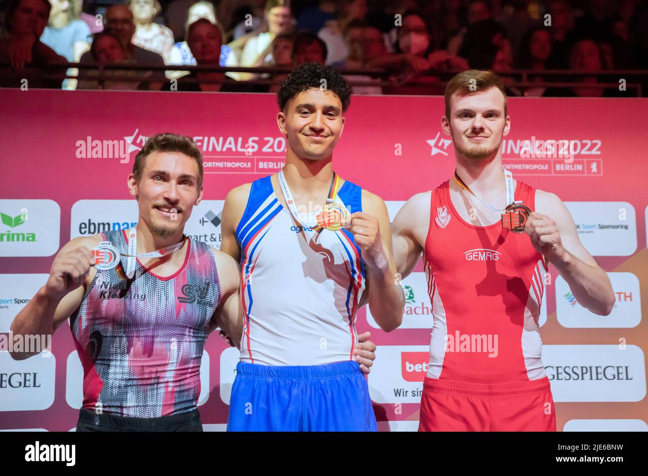 Berlin, Germany. 25th June, 2022. Gymnastics: German Championships, apparatus finals 1 men, floor. Nick Klessing (l-r, 2nd place), Milan Hosseini (1st place) and Leonard Prügel (3rd place) at the award ceremony. Credit: Christoph Soeder/dpa/Alamy Live News Stock Photo
