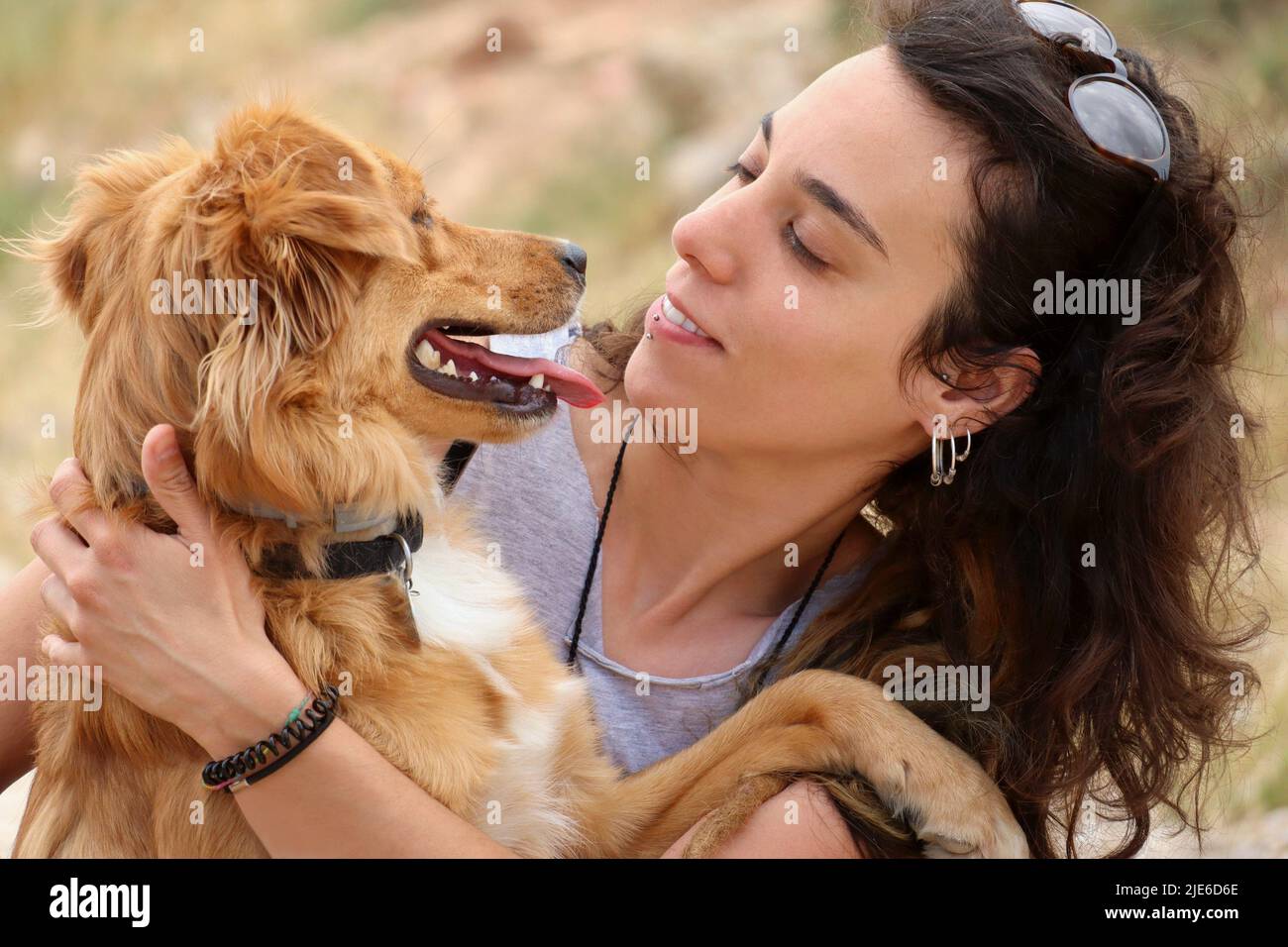 face of a girl looking at her golden retriever dog Stock Photo - Alamy