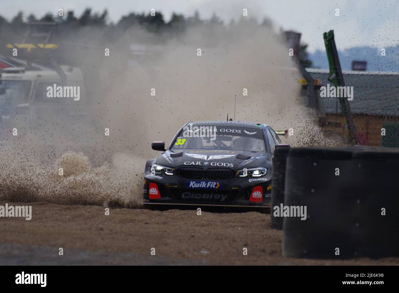 Croft, England, 25 Jun 2022. Adam Morgan driving a BMW 330e M Sport for Car Gods with Ciceley Motorsport paying a visit to the gravel trap during qualification for the Kwik Fit British Touring Car Championship. Credit: Colin Edwards/Alamy Live News Stock Photo