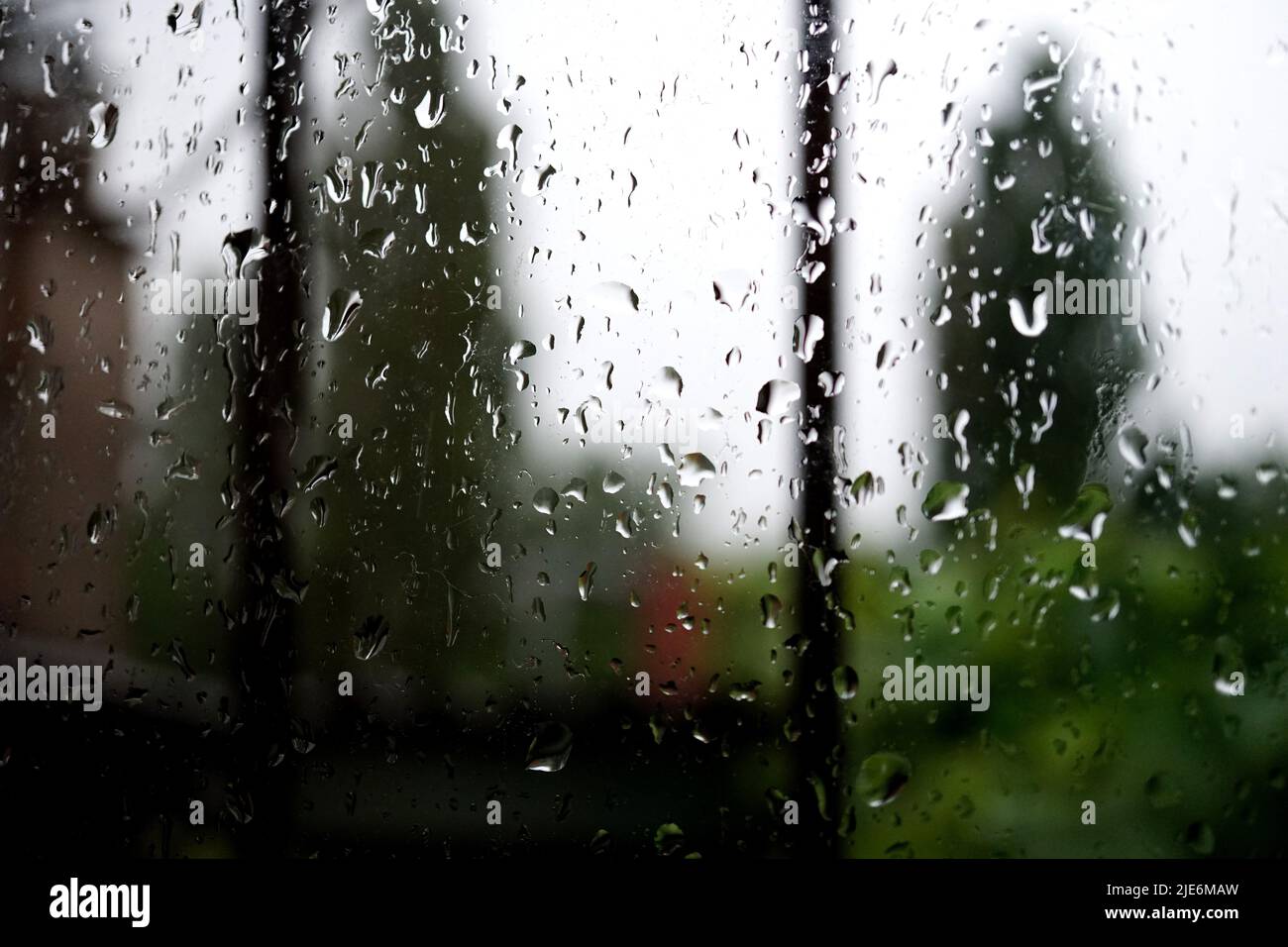 raindrops on the window pane, with blurred background Stock Photo