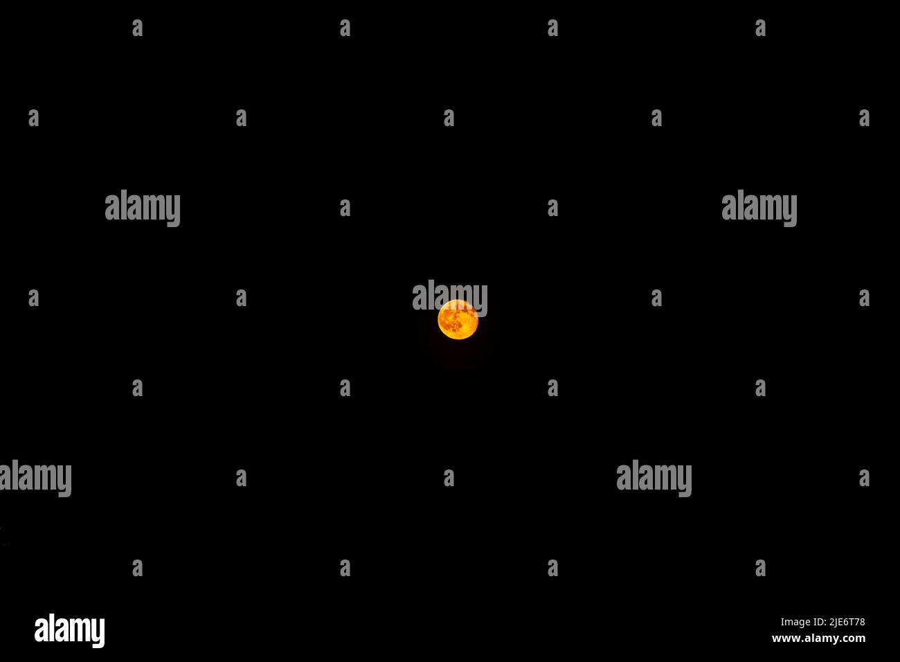 orange moon in a black starless sky, full moon in the sky at night, the