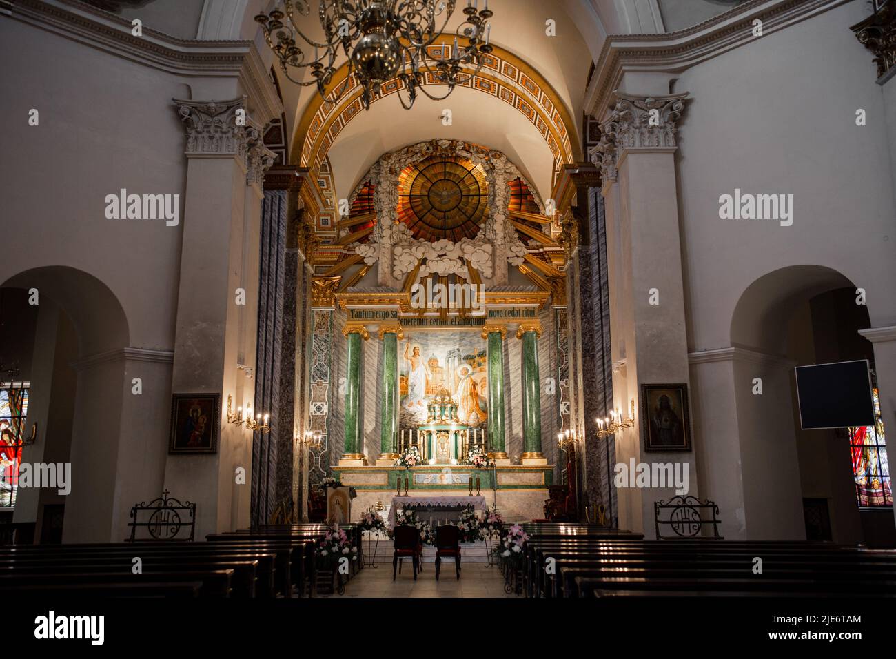 interior of beautiful catholic church with benches icons and ...