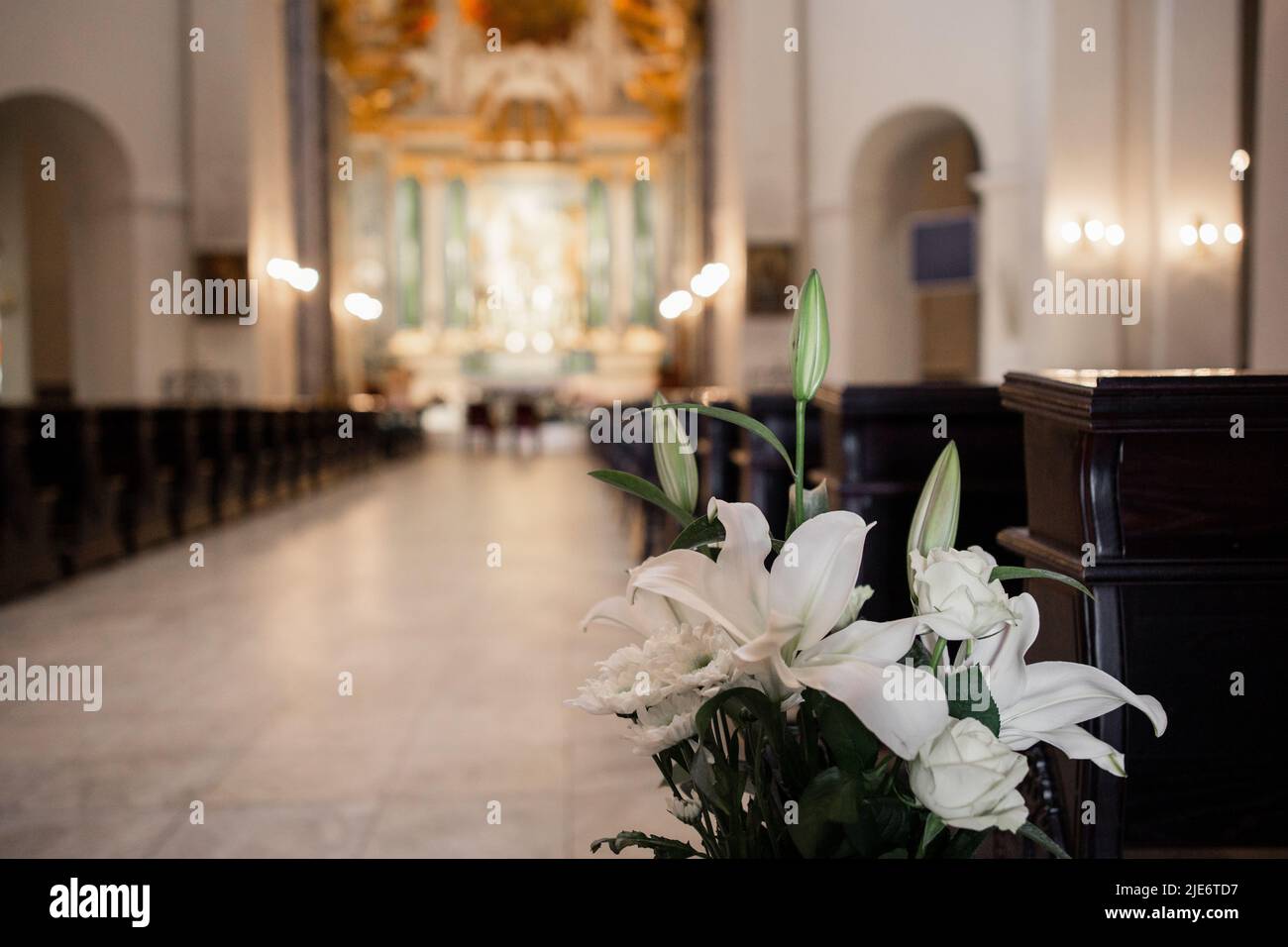 interior of beautiful catholic church with benches icons and ...