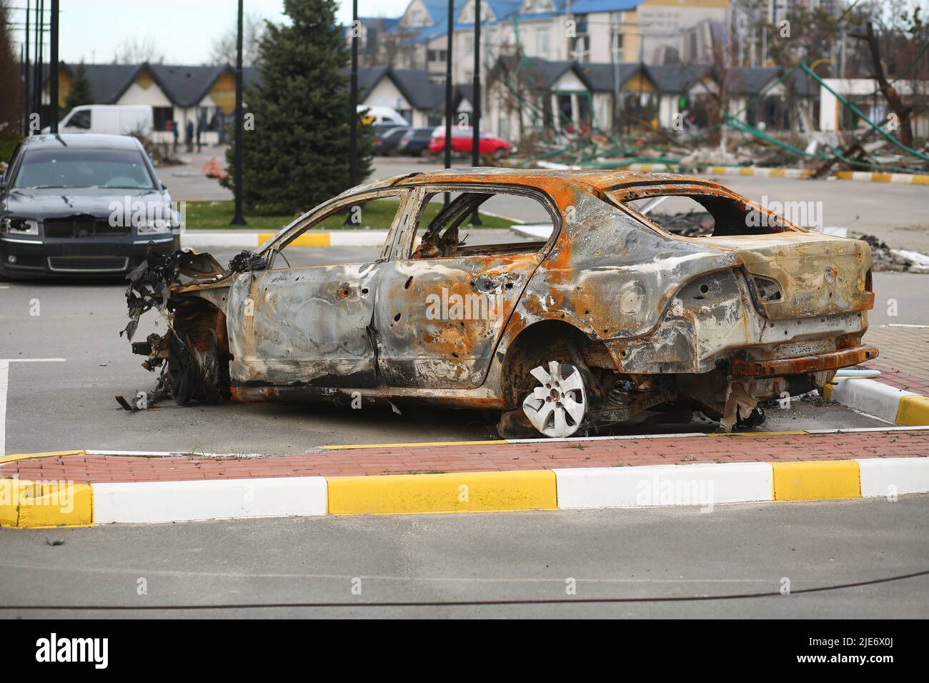 Bucha, Ukraine - April 12, 2022: Cars smashed and burnt by the russian army tanks in the streets of Bucha town during its occupation Stock Photo