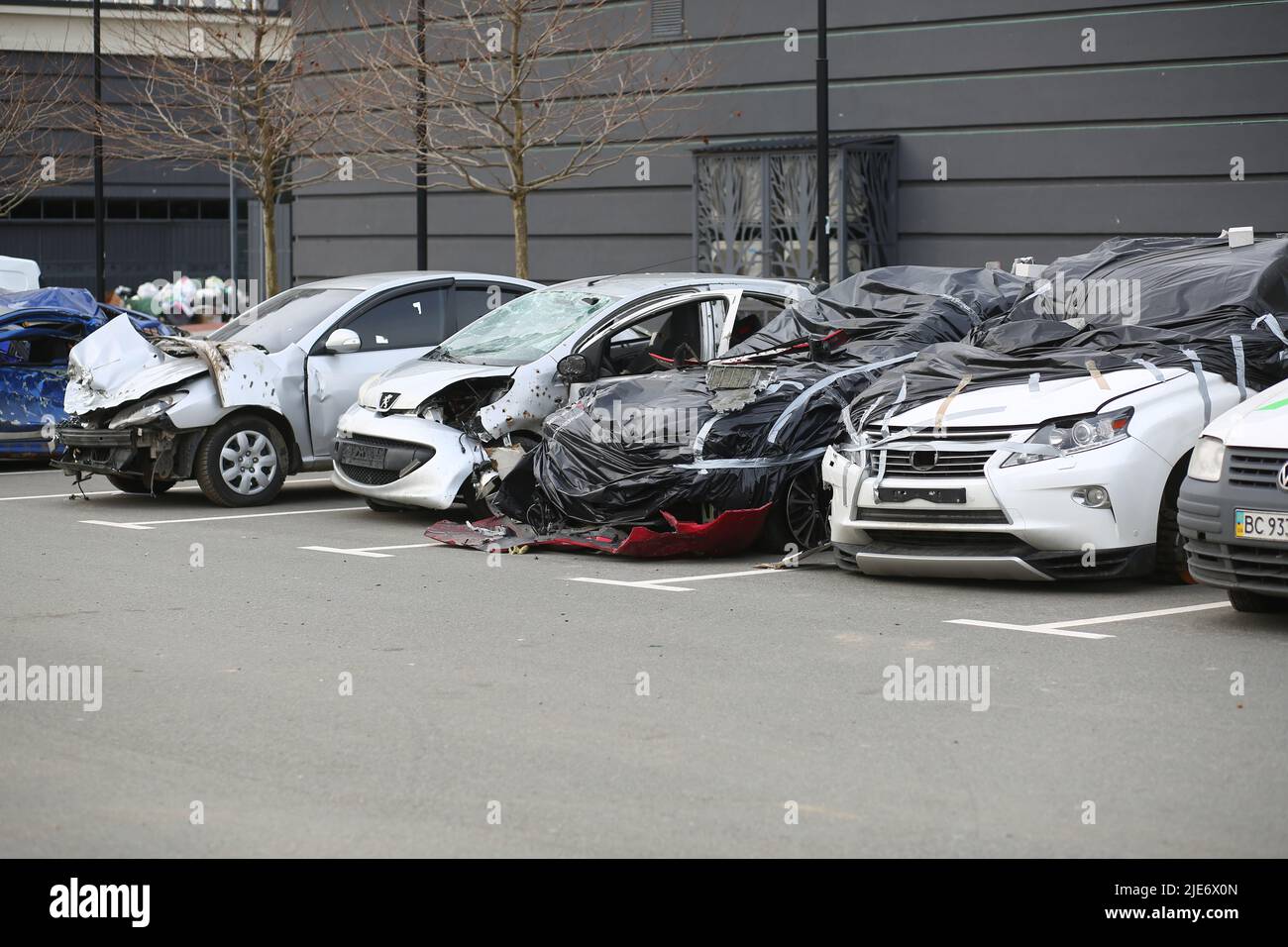 Bucha, Ukraine - April 12, 2022: Cars smashed and burnt by the russian army tanks in the streets of Bucha town during its occupation Stock Photo