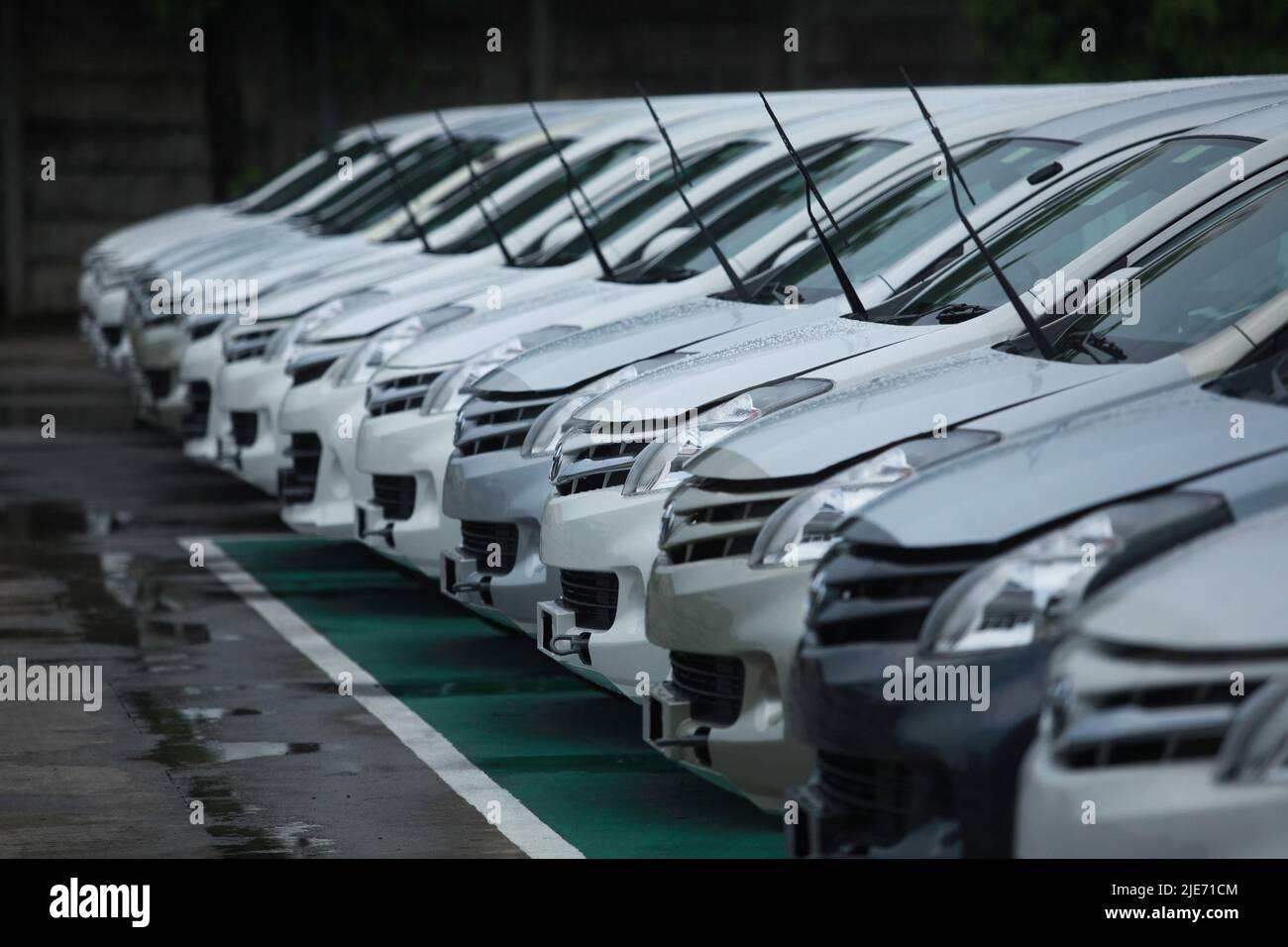 Jakarta,Indonesia-March 22,2013: selective focus on a row of new toyota avanza cars parked after being assembled at the toyota car factory in jakarta Stock Photo