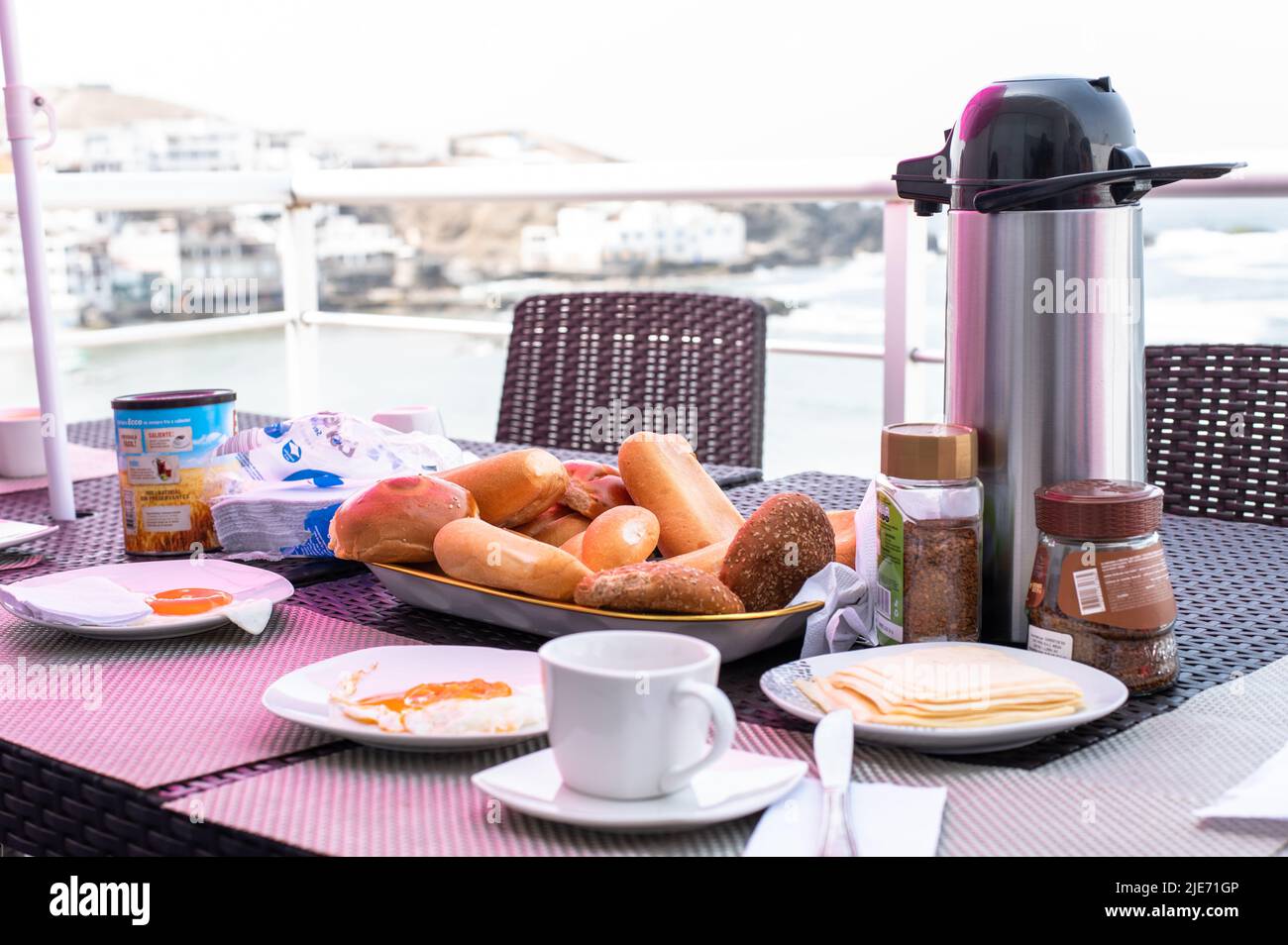 Breakfast on a wood table with a beach front view. French toast for breakfast with sea view. Perfect place for a breakfast delicious Stock Photo