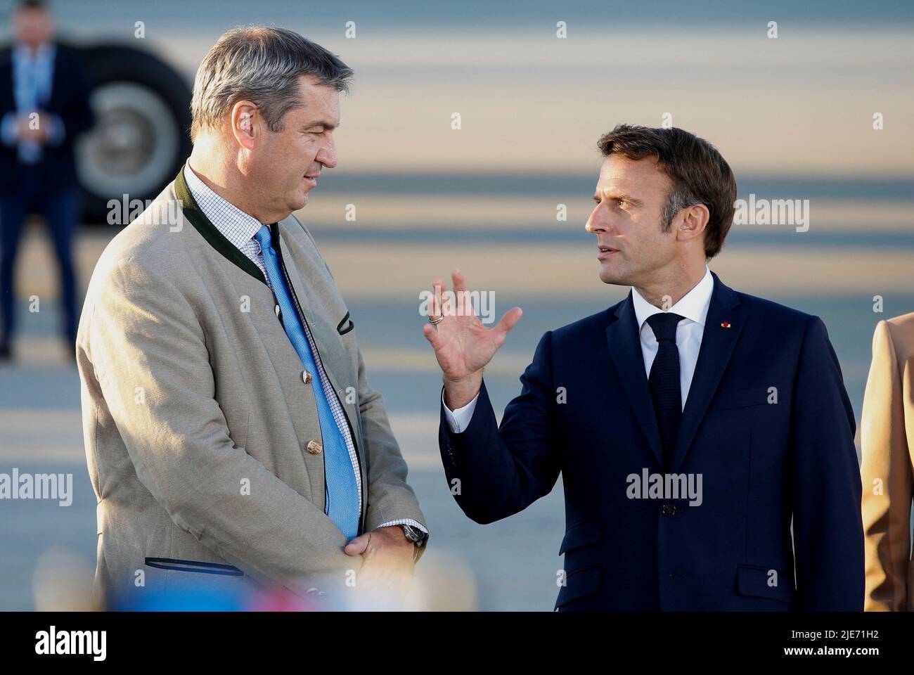 French President Emmanuel Macron is greeted by Bavaria's State Premier Markus Soeder upon his arrival at Franz-Josef-Strauss airport in Munich ahead of the G7 summit, which will take place in the Bavarian alpine resort of Elmau Castle, Germany, June 25, 2022. REUTERS/Michaela Rehle Stock Photo