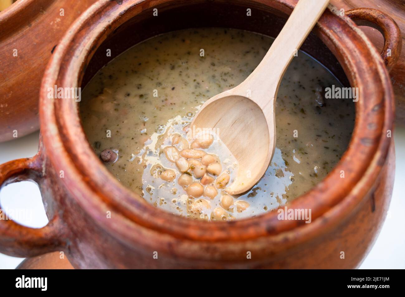 Clay pot with traditional Peruvian food called seco con frejoles Stock Photo