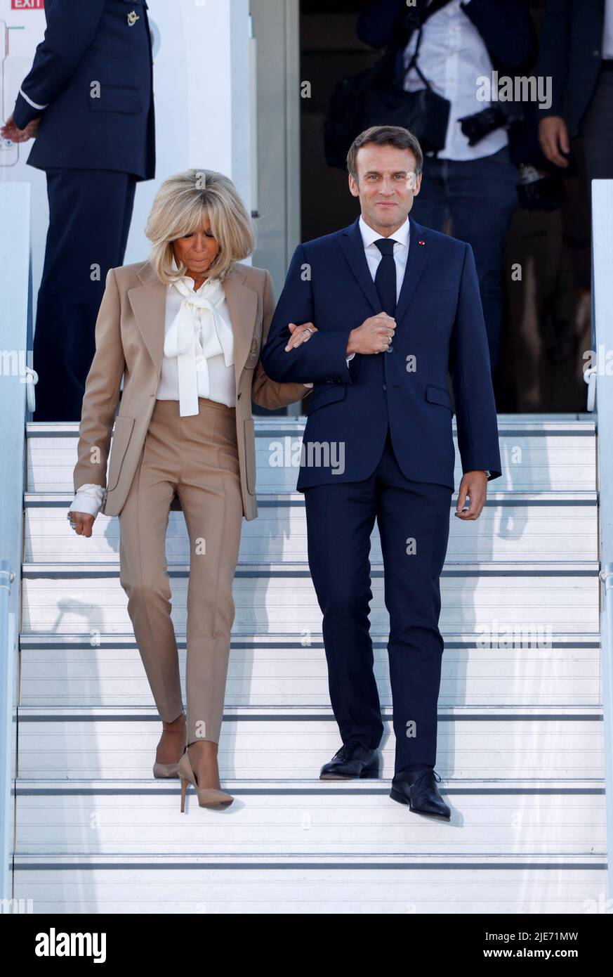 French President Emmanuel Macron and his wife Brigitte Macron exit an airplane as they arrive at Franz-Josef-Strauss airport in Munich ahead of the G7 summit, which will take place in the Bavarian alpine resort of Elmau Castle, Germany, June 25, 2022. REUTERS/Michaela Rehle Stock Photo
