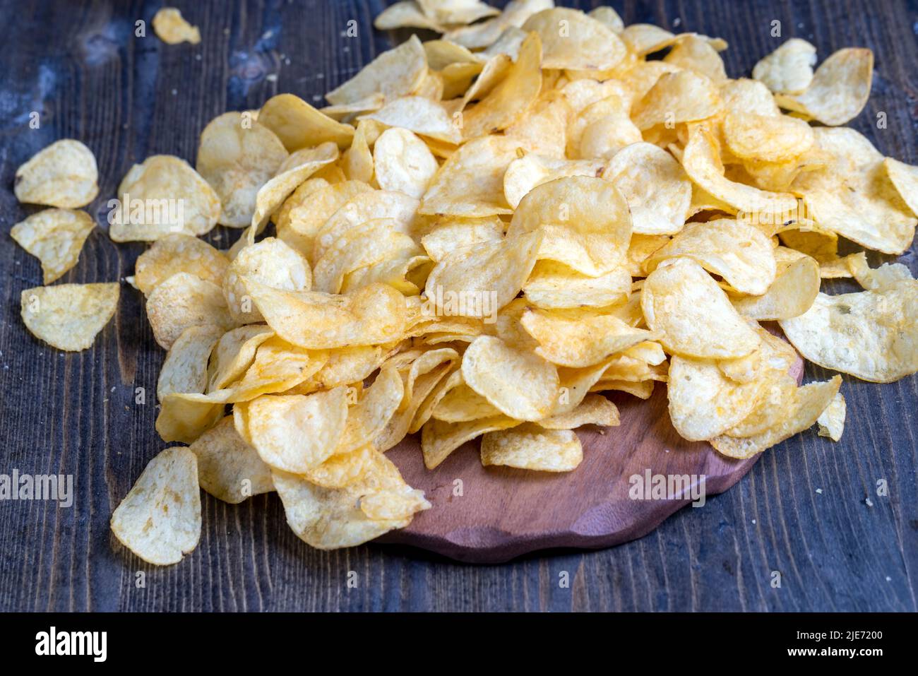 scattered potato chips with natural spices , fried potato chips with