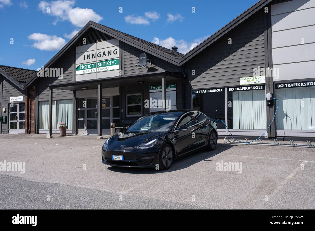 Bo, Norway - May 26, 2022: A static shot of a solid black Tesla Model 3 dual motor charging at the driving school Salto ABL AC charging station in a s Stock Photo