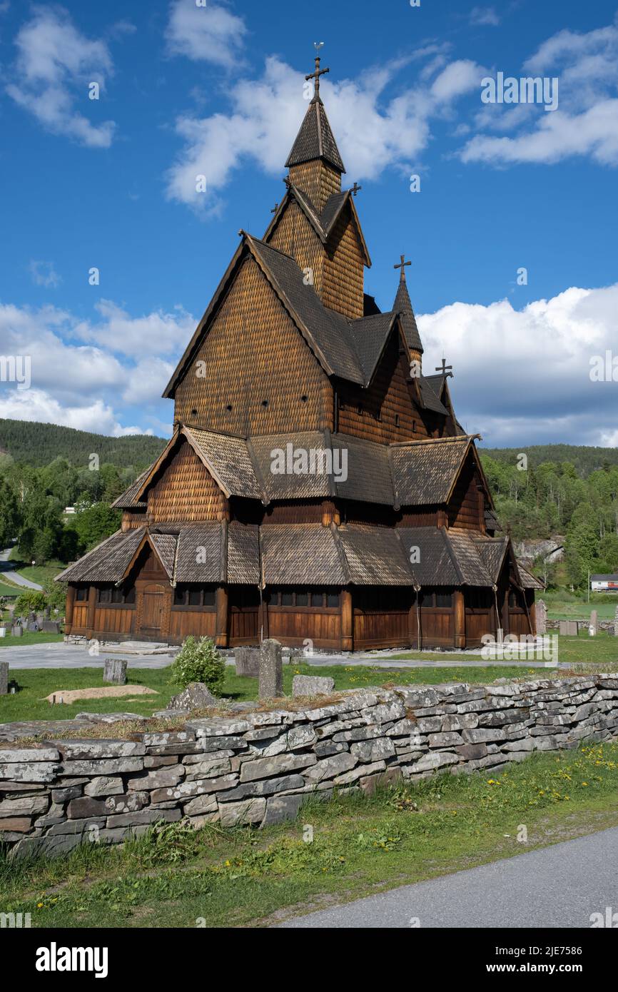 Heddal, Norway - May 26, 2022: Medieval graveyard and Heddal wooden stave church. Heddal Stavkirke, 13th century. Largest stave church in Norway. Stock Photo