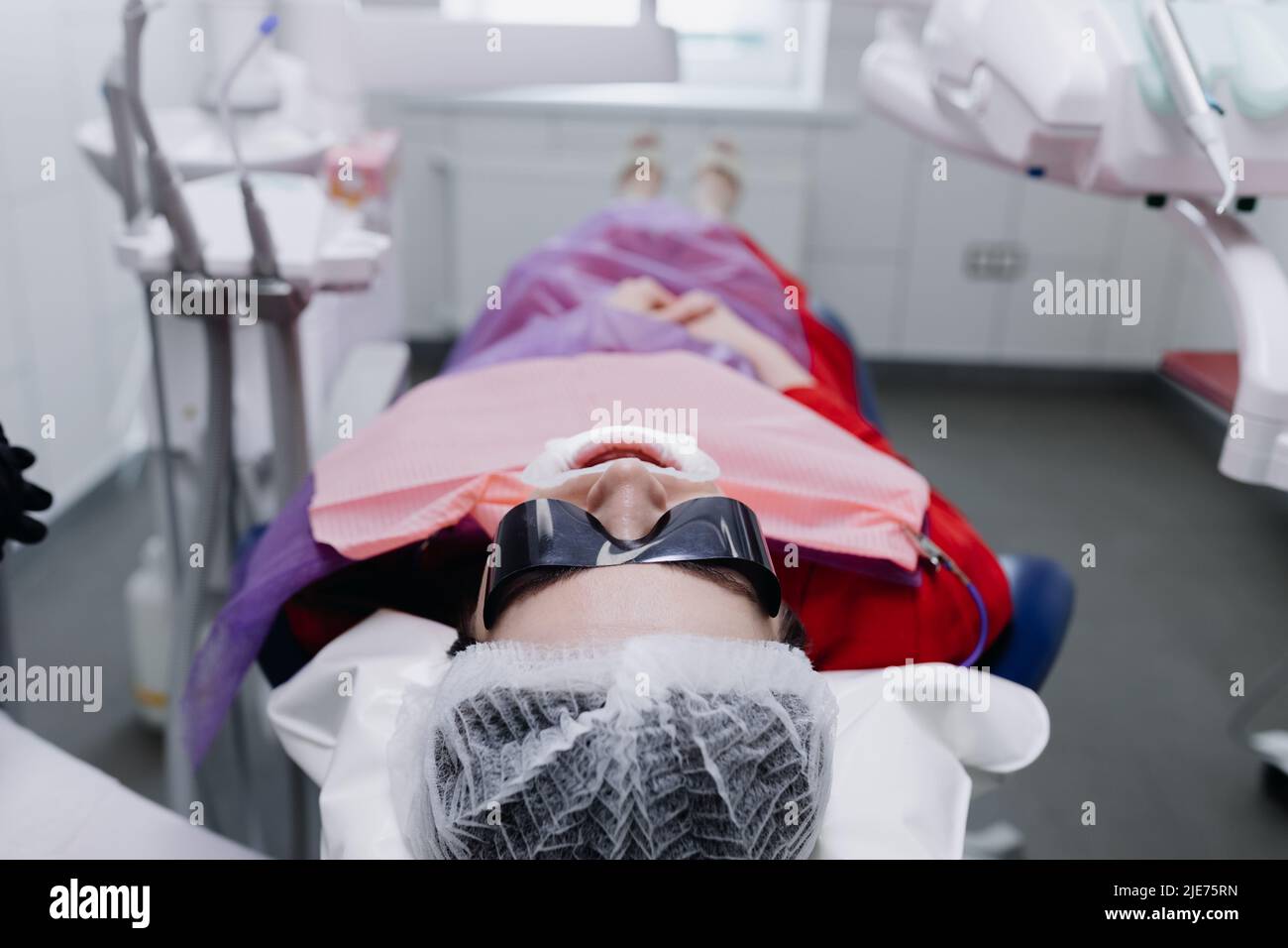 The patient is lying on a dental chair with glasses. Preparing to brush your teeth. High quality photo Stock Photo