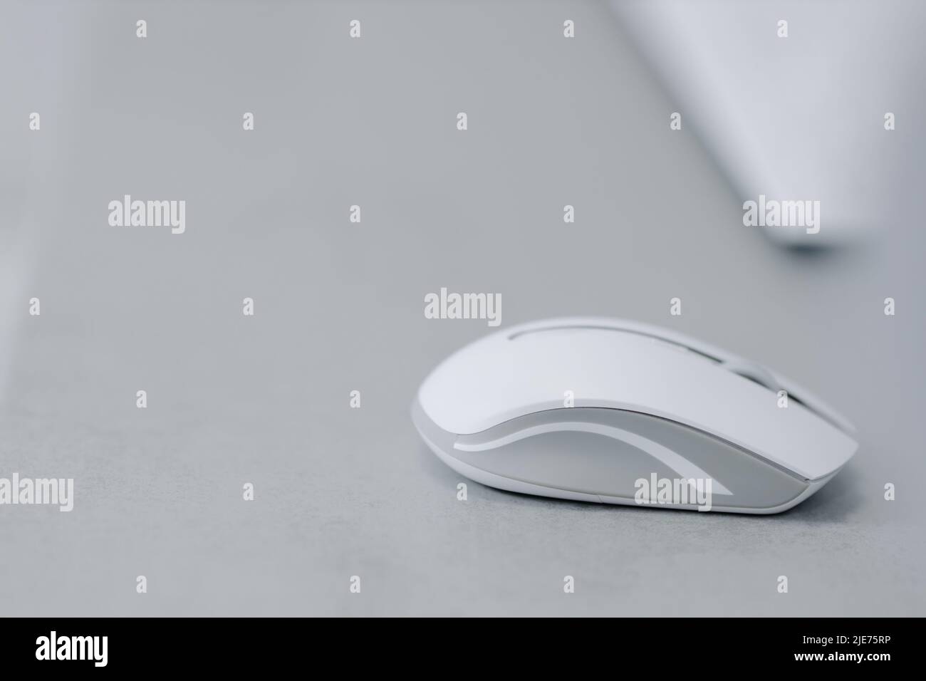 White bluetooth mouse for computer on a gray table. High quality photo Stock Photo