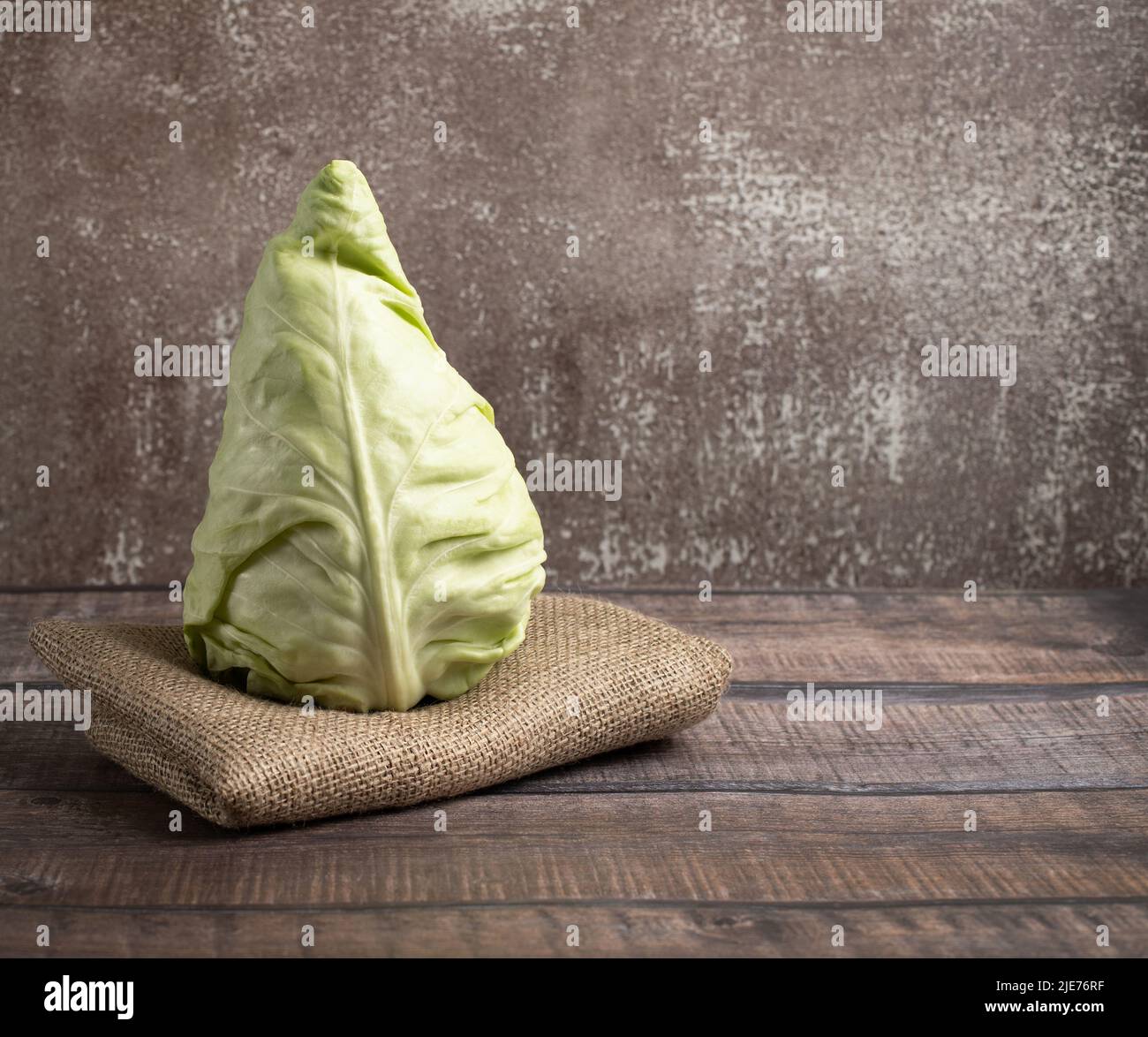 Cone head cabbage for dietary, vegan on a brown background Stock Photo