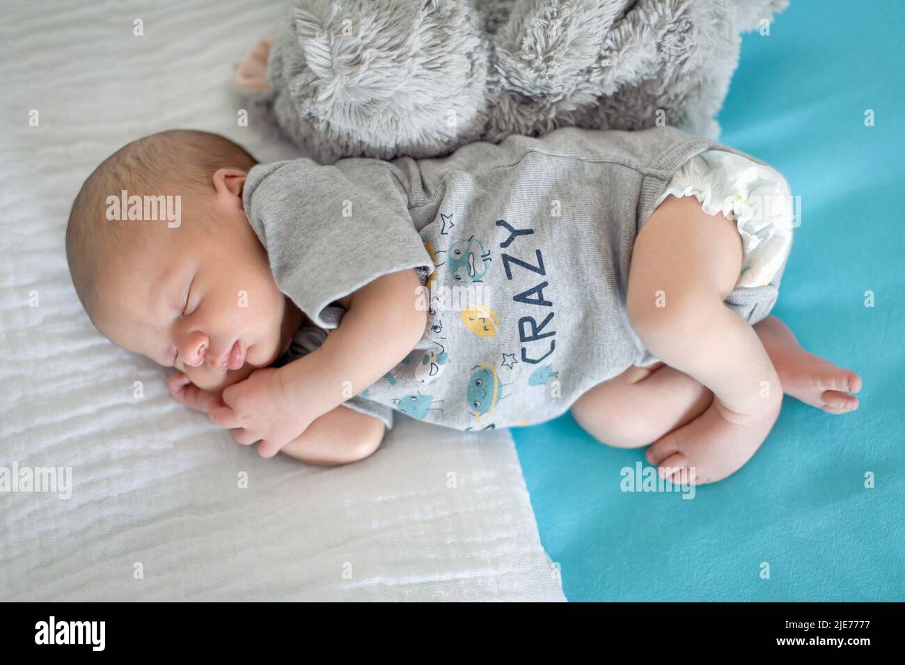 Cute little peaceful baby calm sleeps soundly in his crib with his baby ...