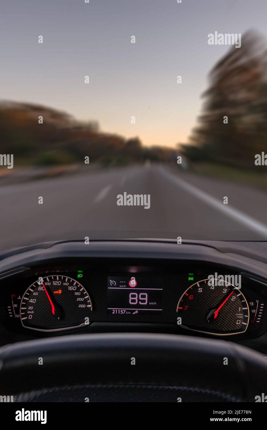 Driver view to the speedometer at 89 kmh or 89 mph and the road blurred in motion night fall view from inside a car of driver POV Point of View Stock Photo Alamy