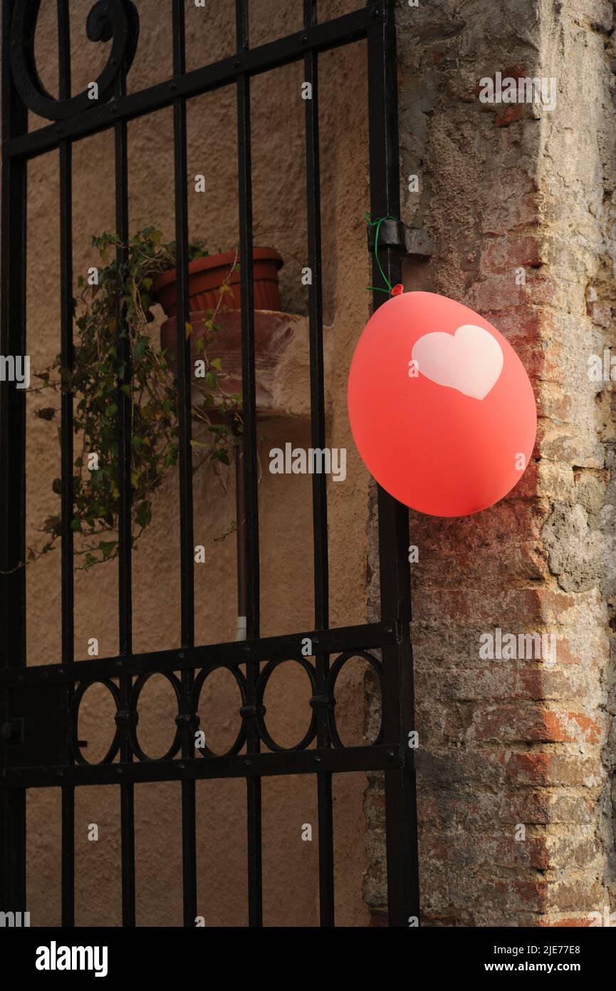 Red balloon with a heart shaped patter Stock Photo